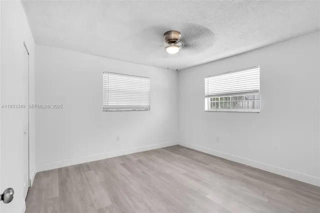 a view of a porch with a table and chairs