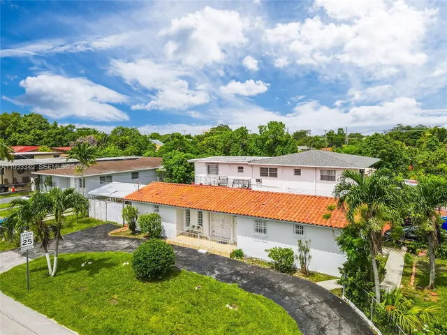 an aerial view of residential houses with outdoor space