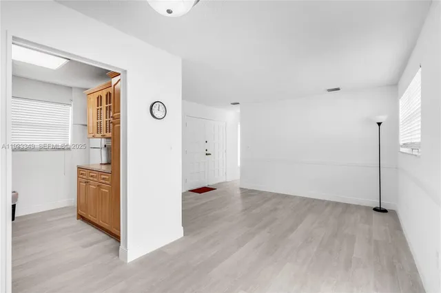 a kitchen with granite countertop a sink a stove and cabinets