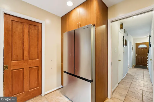 a view of a hallway with a refrigerator
