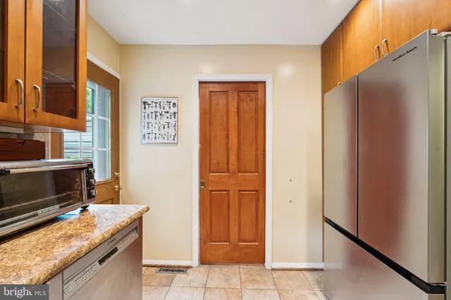 a kitchen with granite countertop a refrigerator and a stove
