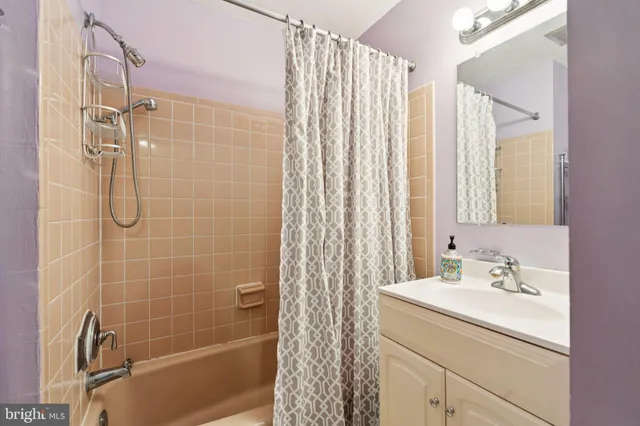 a bathroom with a shower curtain and a toilet