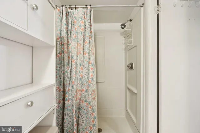 a view of a chair and table in backyard of the house