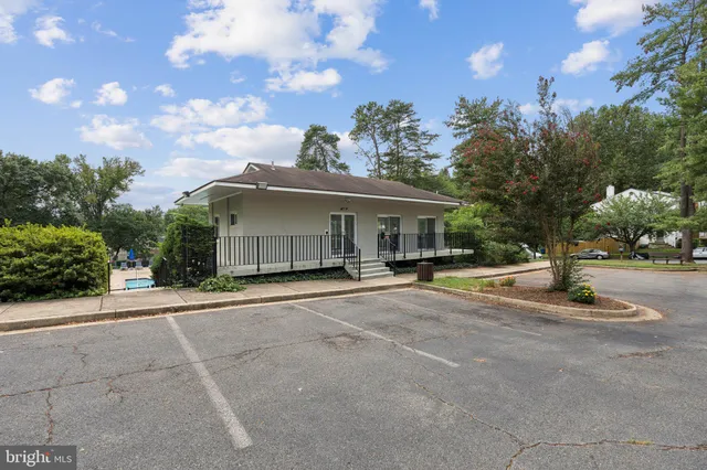 a view of a road with a house in the background