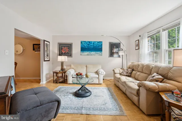 a living room with furniture rug and window