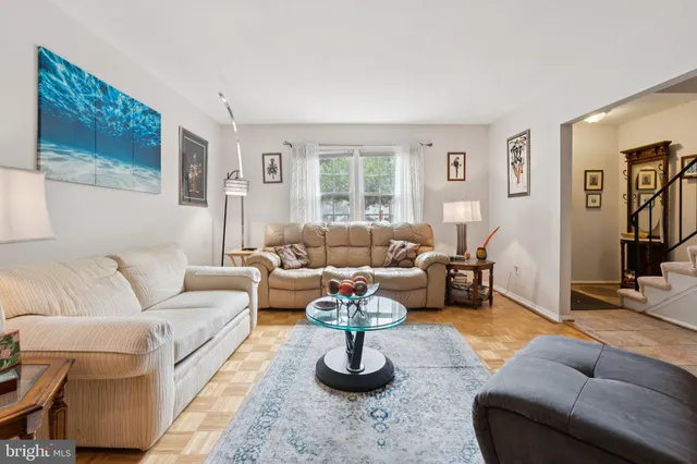 a living room with furniture fireplace and a window
