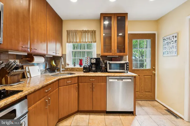 a kitchen with a sink window and cabinets