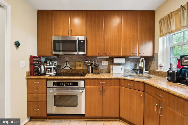 a kitchen with a sink stove and microwave