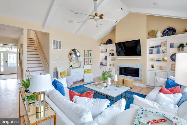 a living room with fireplace furniture and a flat screen tv
