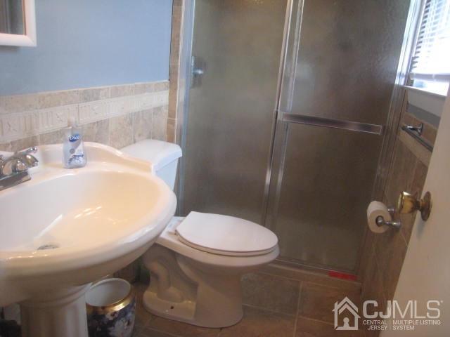 22 King Road Somerset, NJ 08873 - Photo 12 of 19 a white toilet sitting next to a bathroom sink