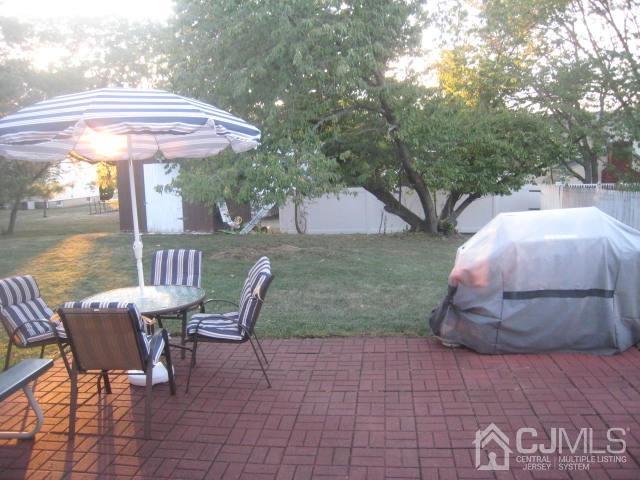 22 King Road Somerset, NJ 08873 - Photo 17 of 19 a view of a patio with a table chairs and a fire pit