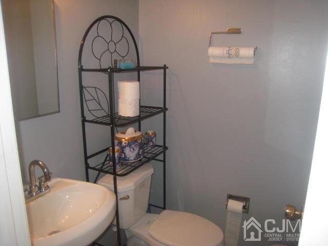 22 King Road Somerset, NJ 08873 - Photo 19 of 19 a bathroom with a toilet sink and mirror