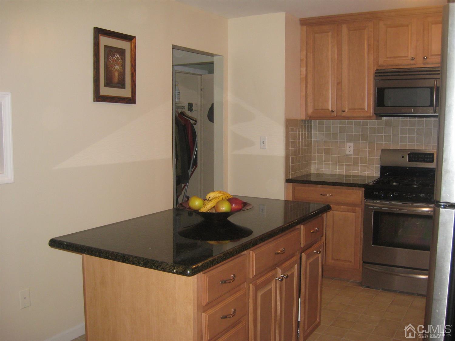 22 King Road Somerset, NJ 08873 - Photo 5 of 19 a kitchen with granite countertop a stove and a refrigerator