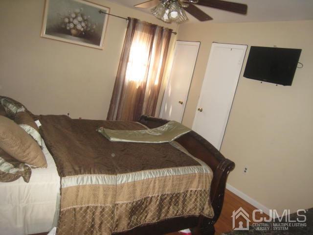 22 King Road Somerset, NJ 08873 - Photo 10 of 19 a bed sitting in a bedroom next to a window and a chandelier