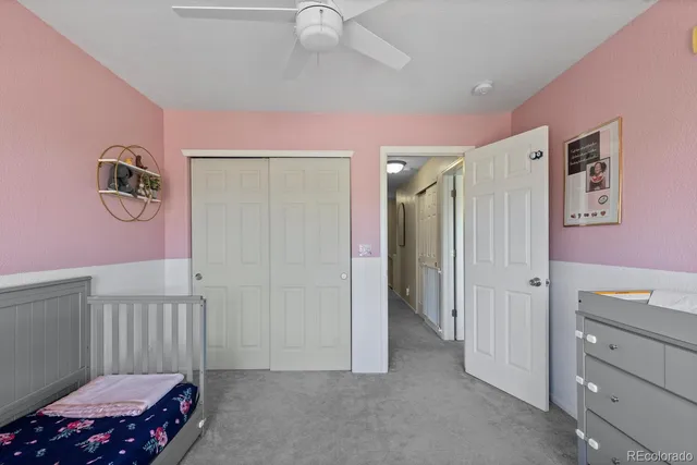 a bedroom with furniture and a baby crib