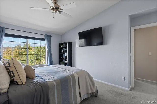 a bedroom with a large bed and a flat screen tv