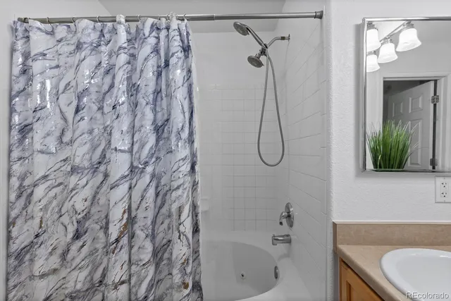 a bathroom with a bath tub and shower