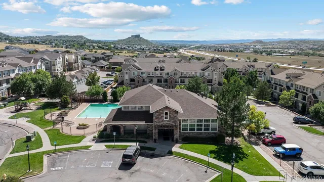 an aerial view of a house with garden space and street view