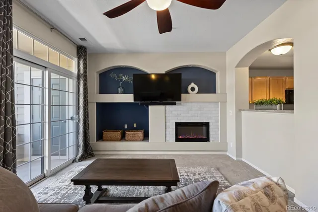 a living room with furniture and a fireplace