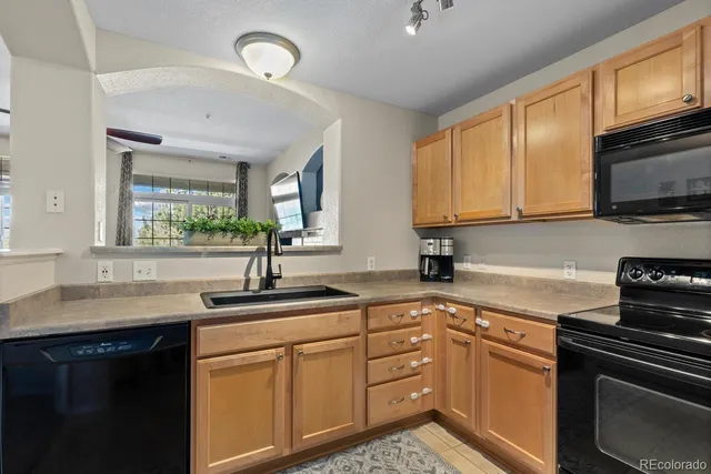a kitchen with a sink stove and microwave