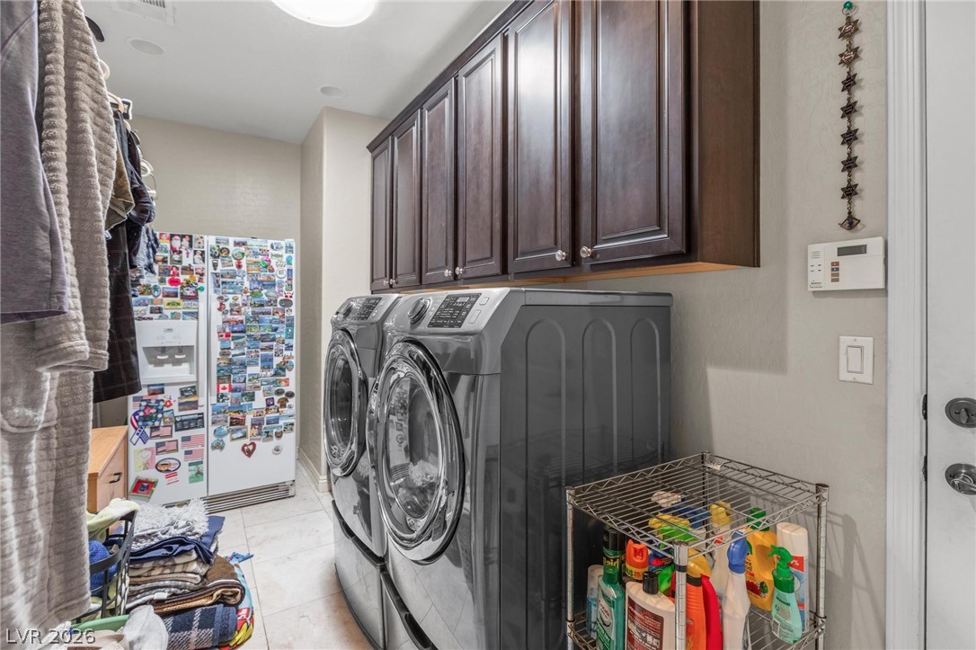 8431 Durango Ranch Court Las Vegas, NV 89113 - Photo 24 of 49 This dedicated laundry space combines practicality and ample storage for efficient household management.