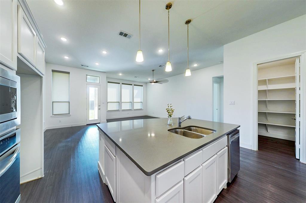 2032 Longbridge Road Forney, TX 75126 - Photo 12 of 40 a kitchen with a table chairs and wooden floor