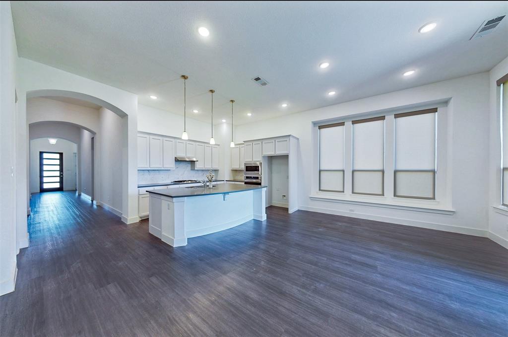 2032 Longbridge Road Forney, TX 75126 - Photo 19 of 40 a large kitchen with a large counter top a sink stainless steel appliances and cabinets