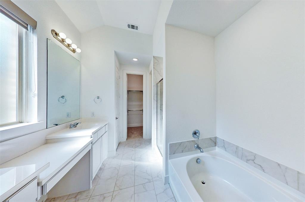 2032 Longbridge Road Forney, TX 75126 - Photo 25 of 40 a bathroom with a tub sink and mirror