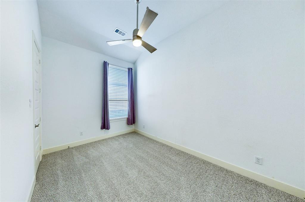 2032 Longbridge Road Forney, TX 75126 - Photo 28 of 40 an empty room with a chandelier fan and windows