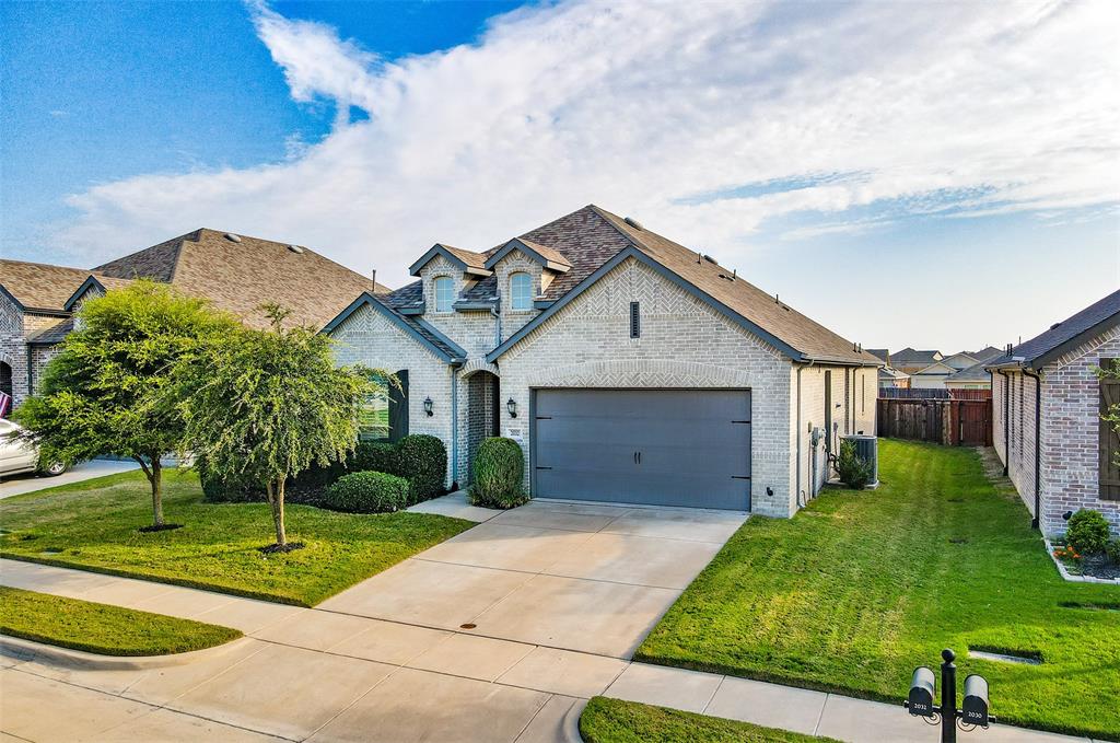 2032 Longbridge Road Forney, TX 75126 - Photo 3 of 40 a front view of a house with a yard and garage