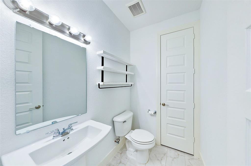 2032 Longbridge Road Forney, TX 75126 - Photo 31 of 40 a bathroom with a sink a toilet and shower