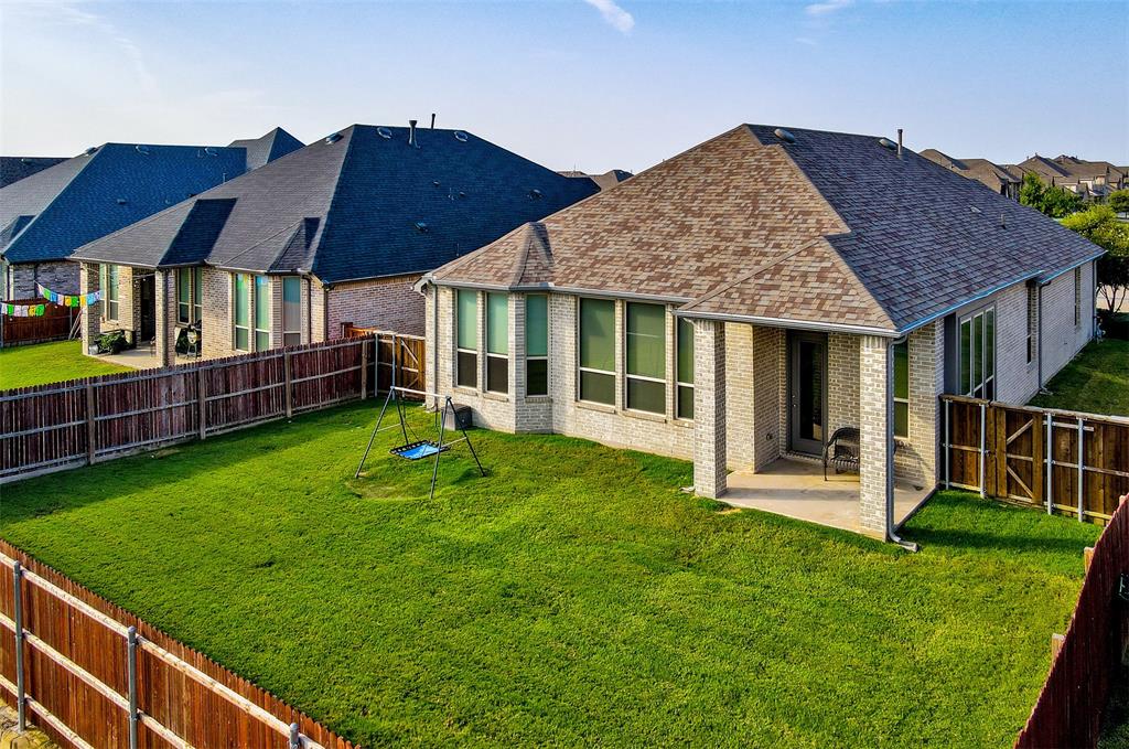 2032 Longbridge Road Forney, TX 75126 - Photo 36 of 40 a view of a house with backyard and porch