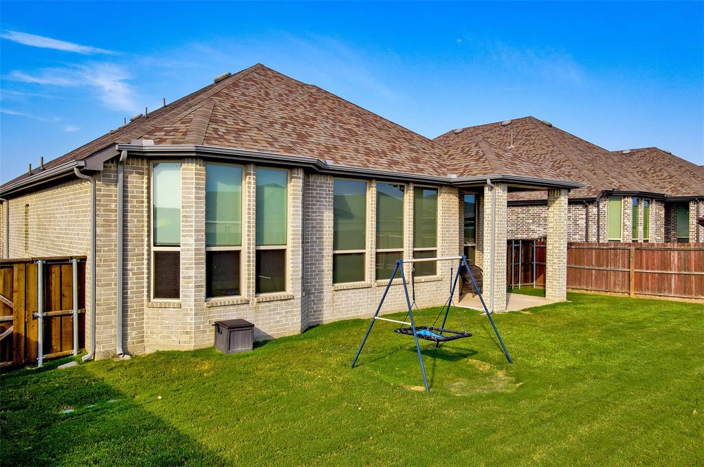2032 Longbridge Road Forney, TX 75126 - Photo 40 of 40 a view of a house with backyard porch and a small cabin