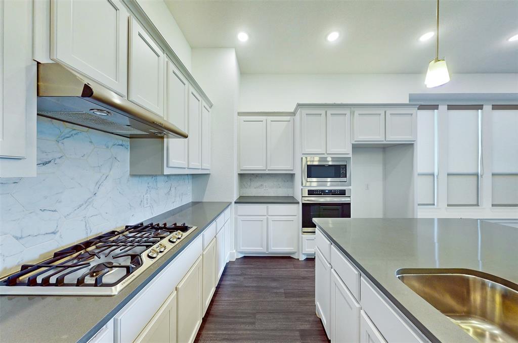 2032 Longbridge Road Forney, TX 75126 - Photo 10 of 40 a kitchen with stainless steel appliances granite countertop a sink and stove