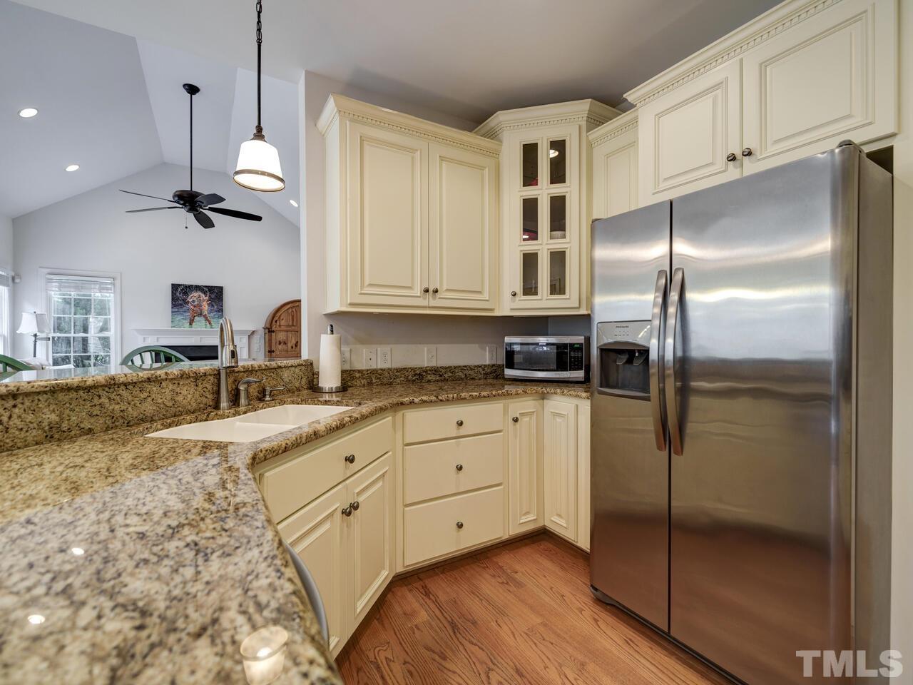 361 Sandy Point Drive Manson, NC 27553 - Photo 19 of 49 a kitchen with stainless steel appliances granite countertop a refrigerator a sink and white cabinets