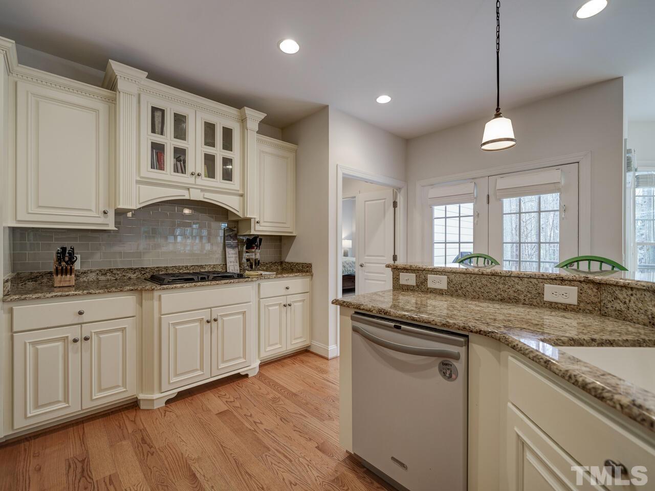 361 Sandy Point Drive Manson, NC 27553 - Photo 20 of 49 a kitchen with granite countertop cabinets stainless steel appliances and a wooden floor