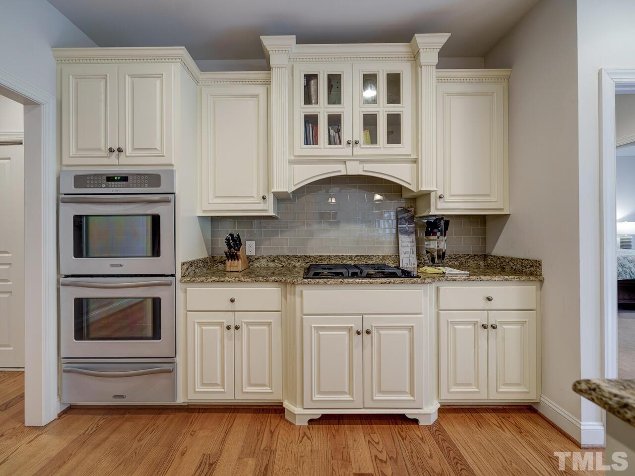 361 Sandy Point Drive Manson, NC 27553 - Photo 21 of 49 a kitchen with stainless steel appliances granite countertop a sink and cabinets with wooden floor