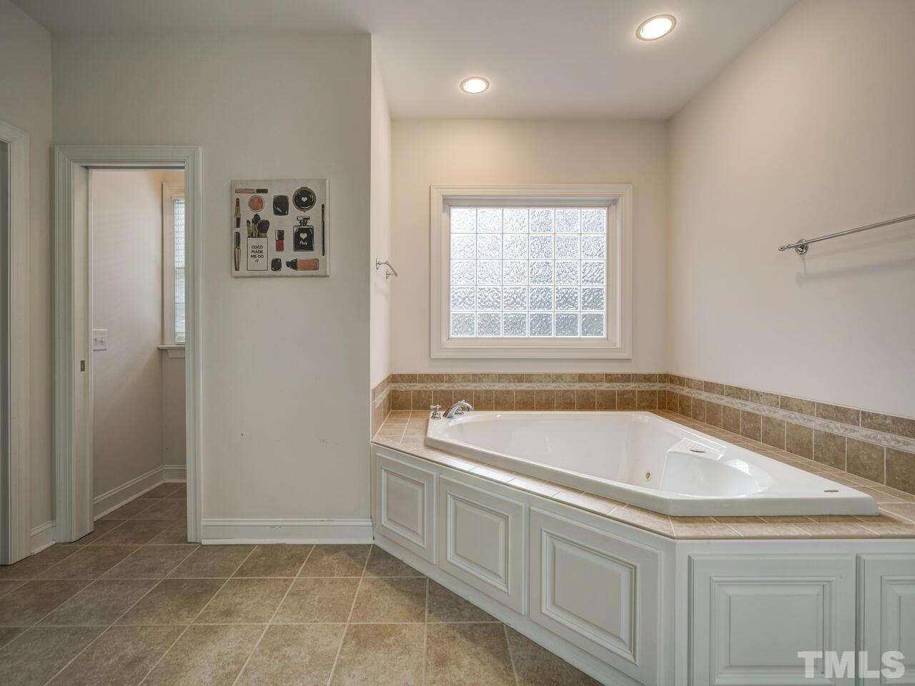361 Sandy Point Drive Manson, NC 27553 - Photo 28 of 49 a white bath tub sitting in a bathroom next to a window