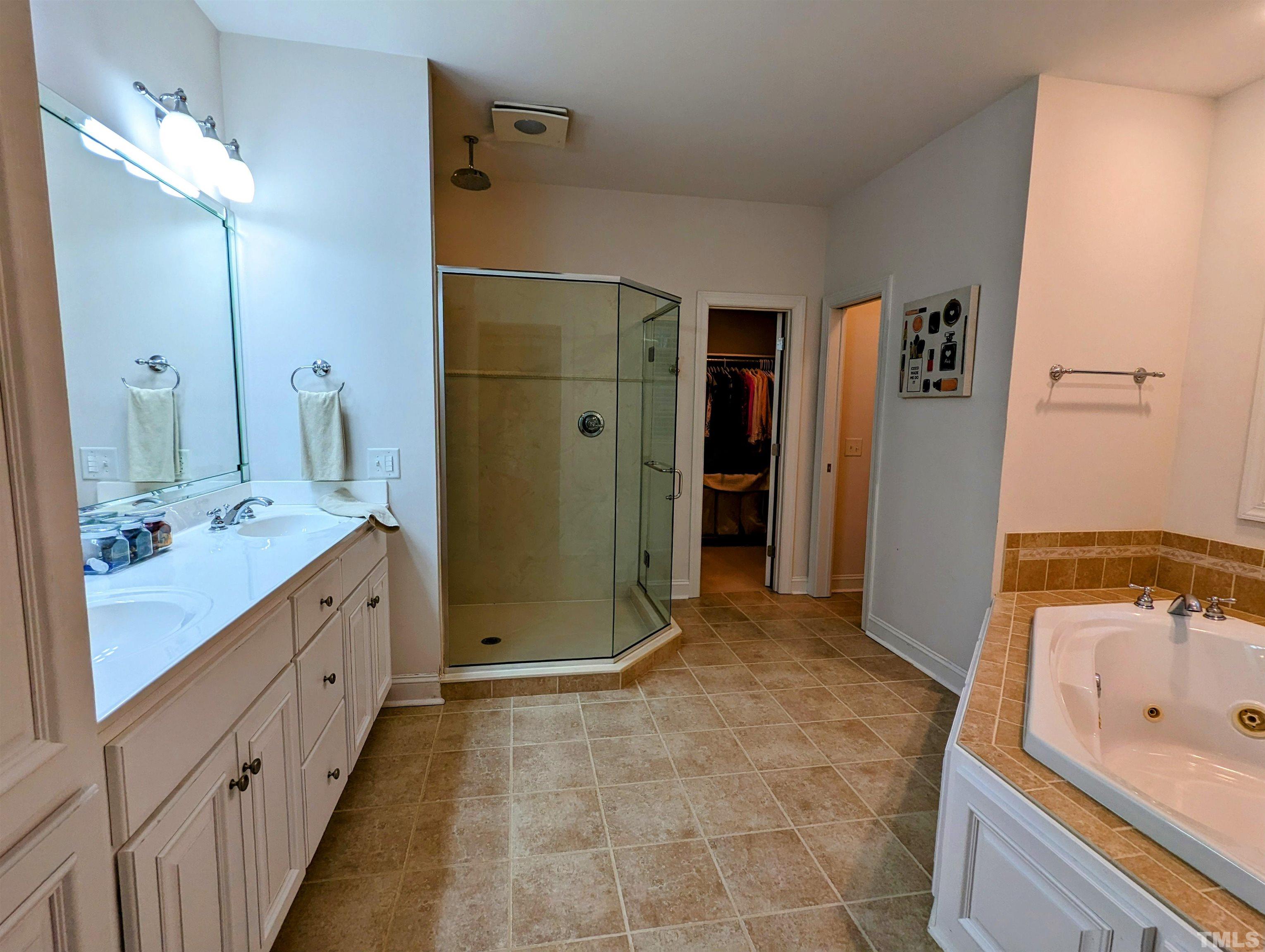 361 Sandy Point Drive Manson, NC 27553 - Photo 29 of 49 a bathroom with a double vanity sink a large mirror and a shower