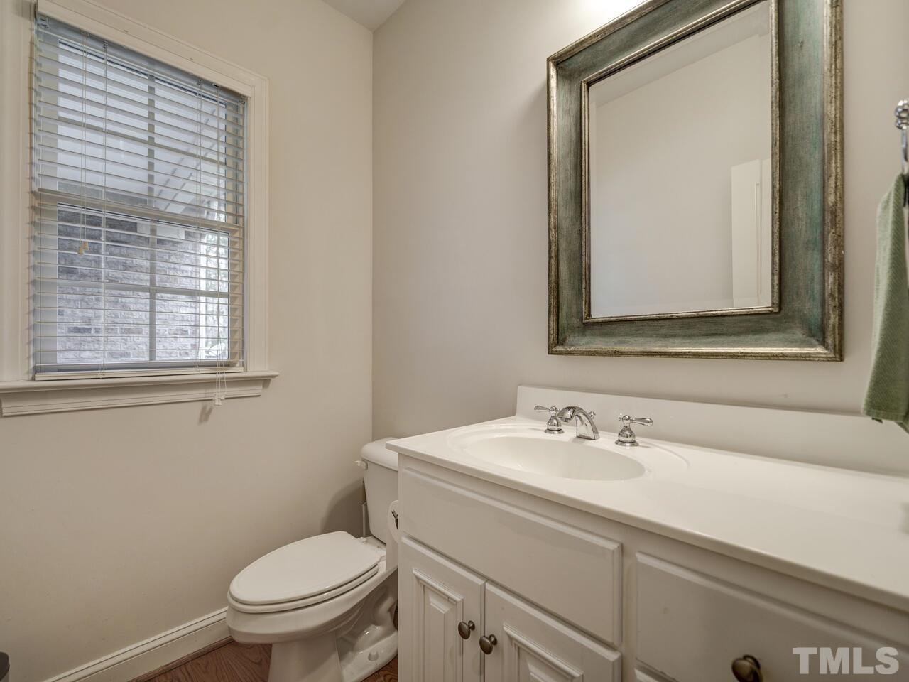 361 Sandy Point Drive Manson, NC 27553 - Photo 31 of 49 a bathroom with a toilet sink and mirror