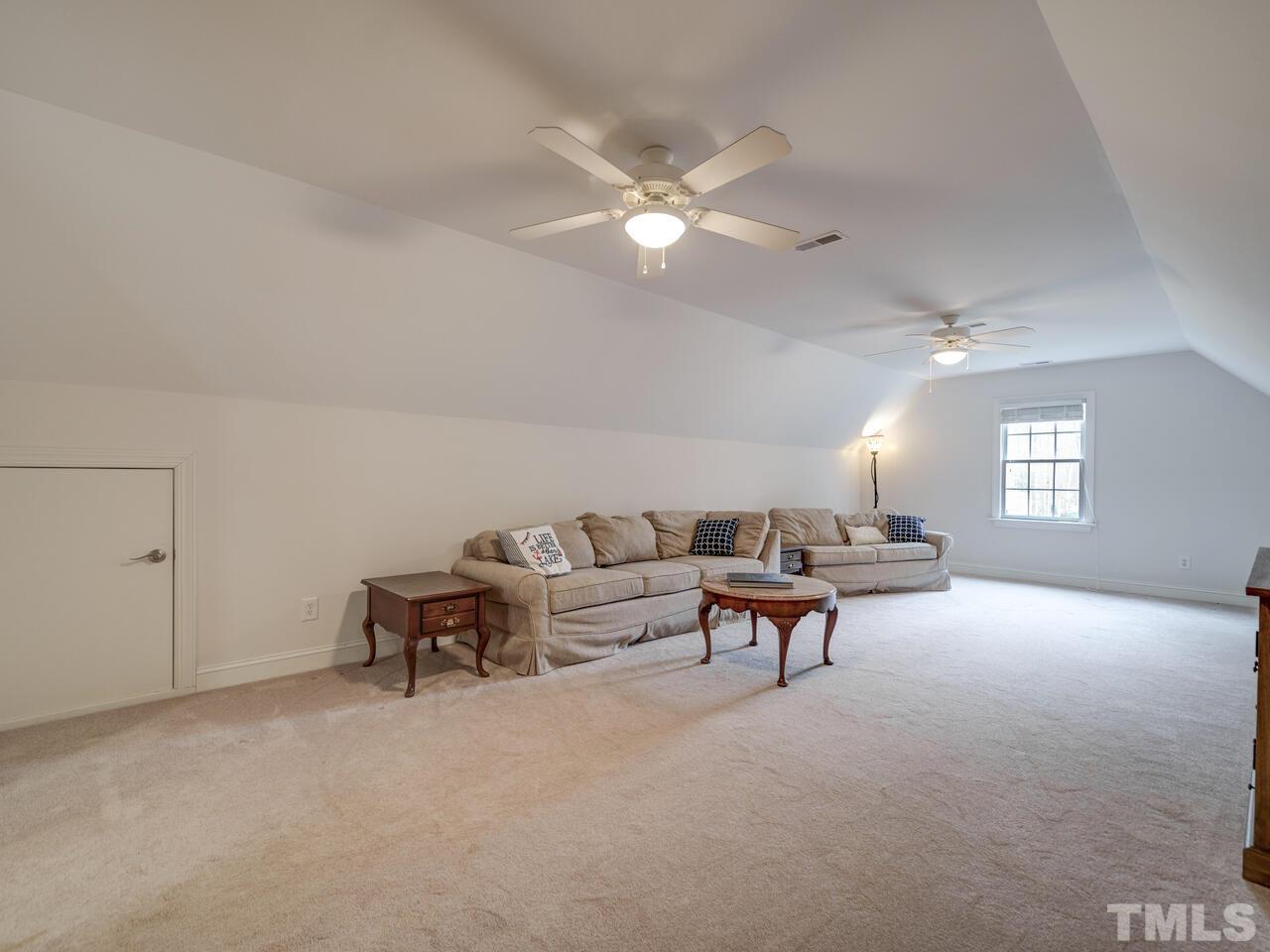 361 Sandy Point Drive Manson, NC 27553 - Photo 33 of 49 a living room with furniture and a chandelier