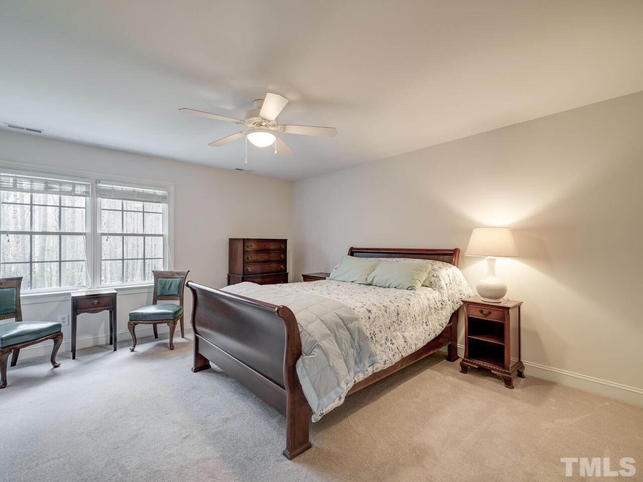 361 Sandy Point Drive Manson, NC 27553 - Photo 36 of 49 a bedroom with a bed and a chandelier