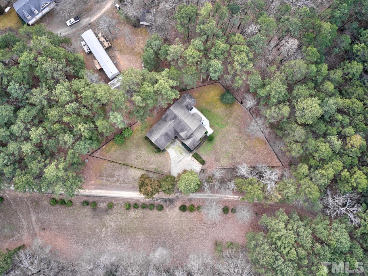 361 Sandy Point Drive Manson, NC 27553 - Photo 44 of 49 an aerial view of a house with a yard and greenery