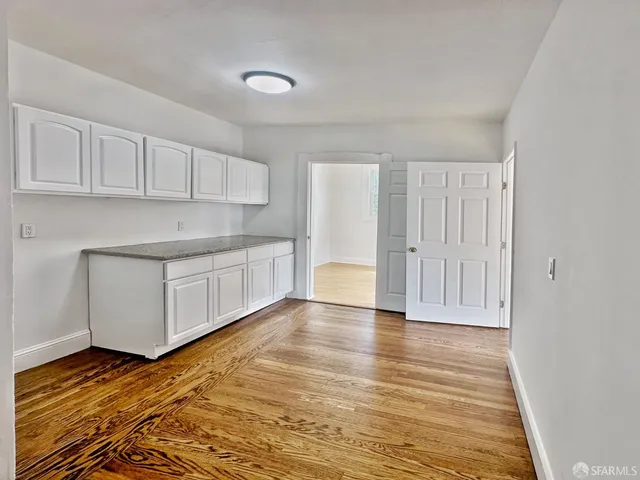 a view of a kitchen with wooden floor
