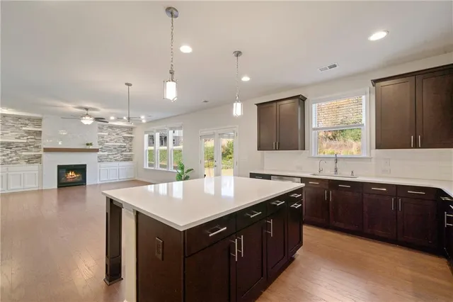 a kitchen with granite countertop a sink counter space cabinets and appliances