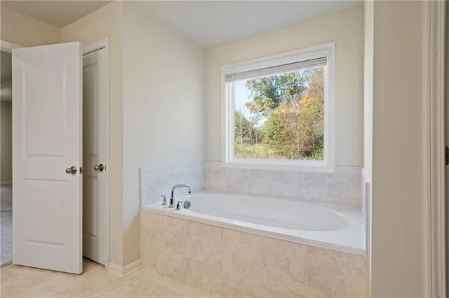 a white bath tub sitting next to a window