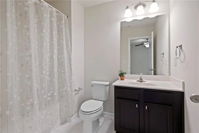 a bathroom with a toilet a sink and a mirror