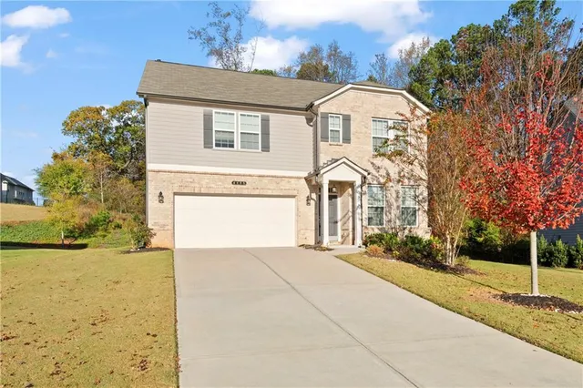 a front view of a house with a yard and garage