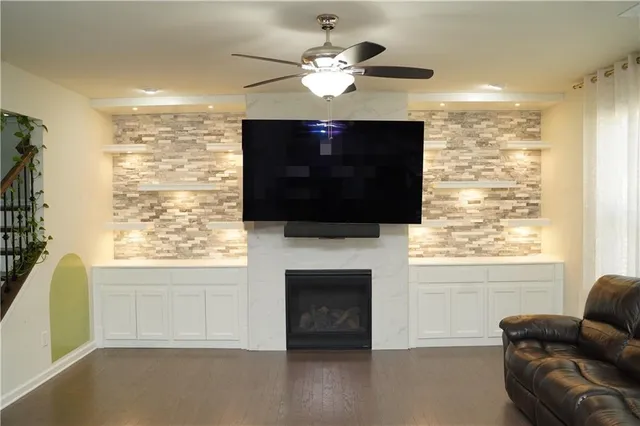 a living room with fireplace furniture and a flat screen tv