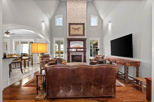 a kitchen with stainless steel appliances kitchen island granite countertop a stove a sink and white cabinets